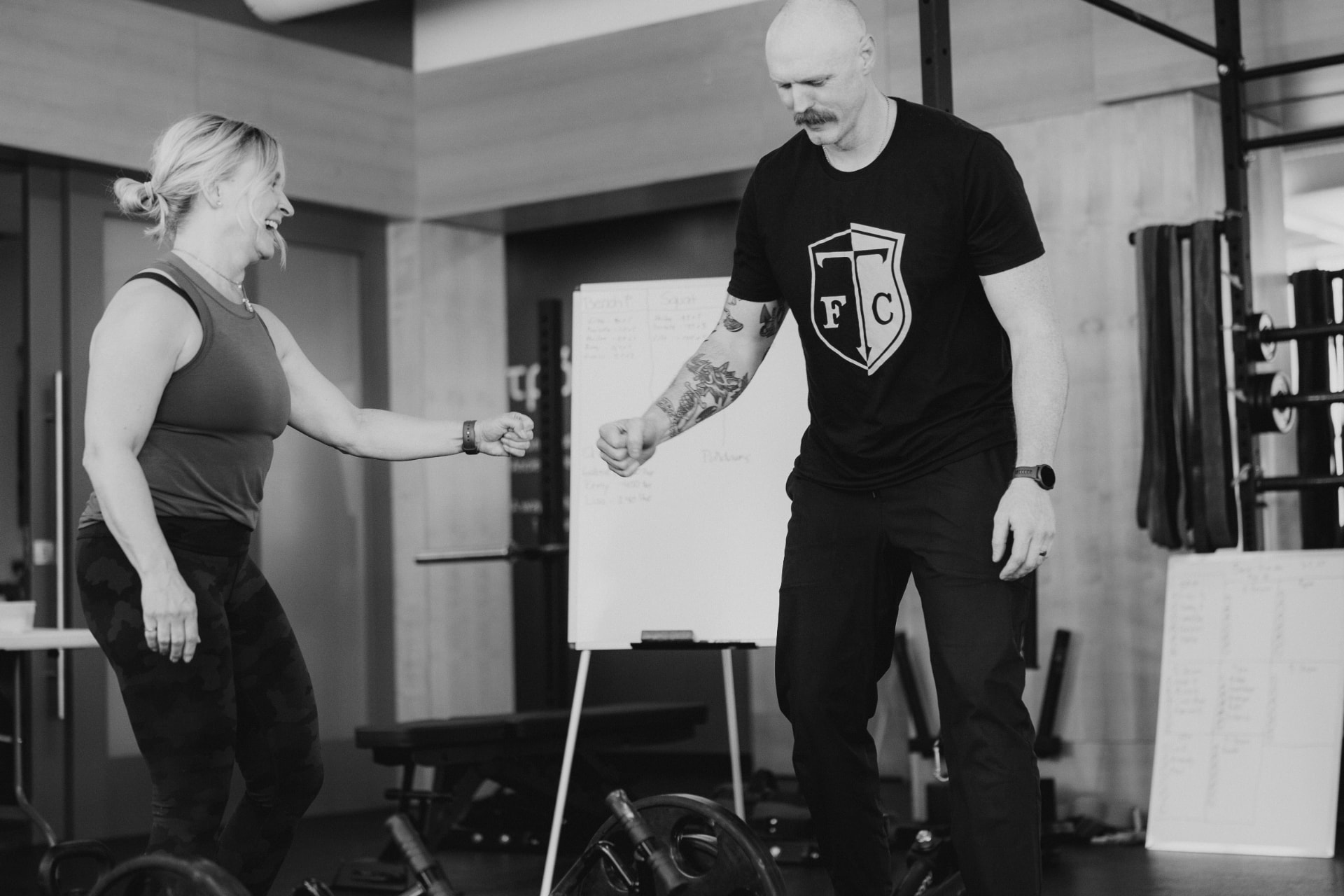 Coach and athlete sharing a fist bump at Tropos