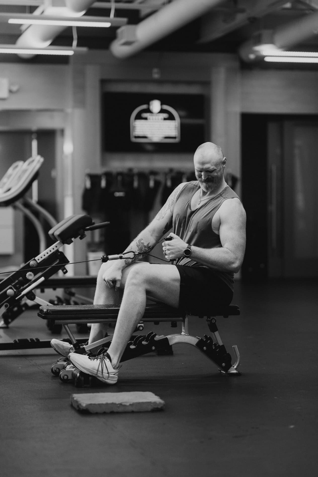 Athlete working a seated cable row at Tropos