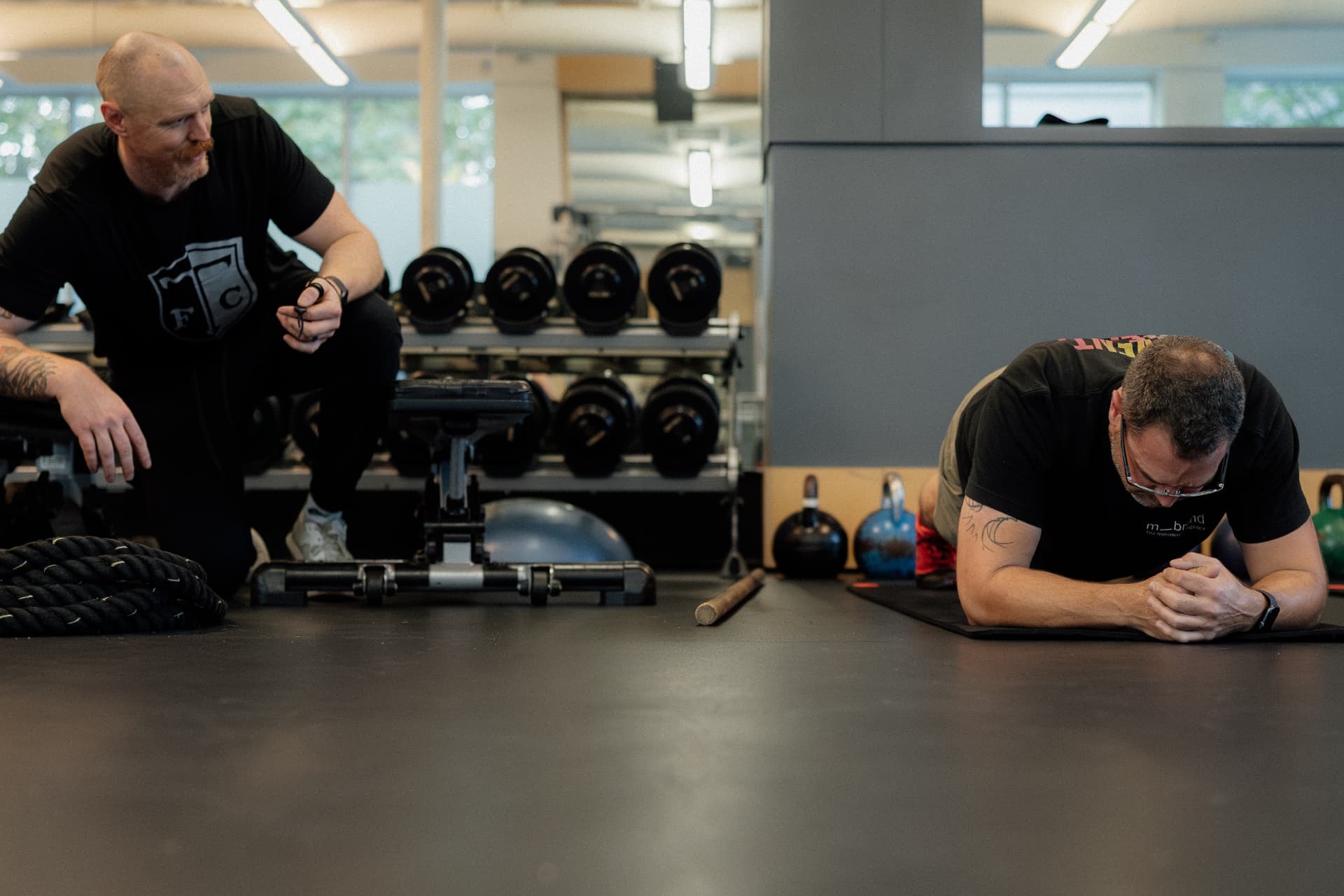 Coach observing a client hold a plank position